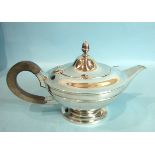 A plain circular teapot of compressed form, the hinged lid with acorn finial, by Goldsmiths,