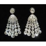 A pair of diamond tassel earrings, each with a millegrain-set old-cut diamond above a rose-cut