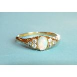 An opal and diamond ring set an opal between triplets of diamond points, in 18ct gold mount, size P,