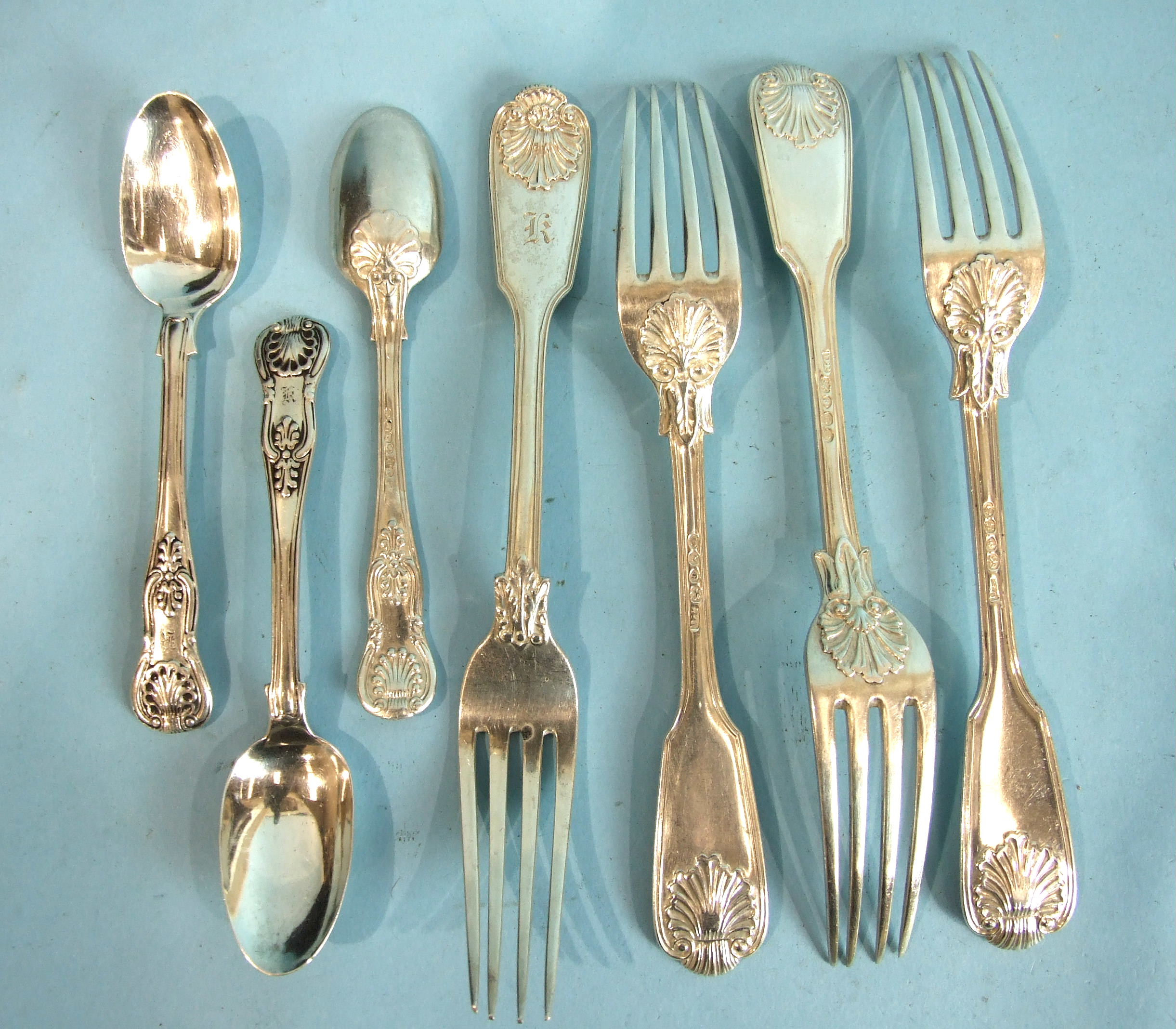 Four fiddle and shell table forks, London 1836 and three Irish teaspoons, ___15½oz.