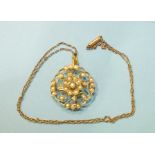 A 9ct gold floral pendant set seed pearls, 28mm diameter, on fine gold chain, total weight 6.4g.