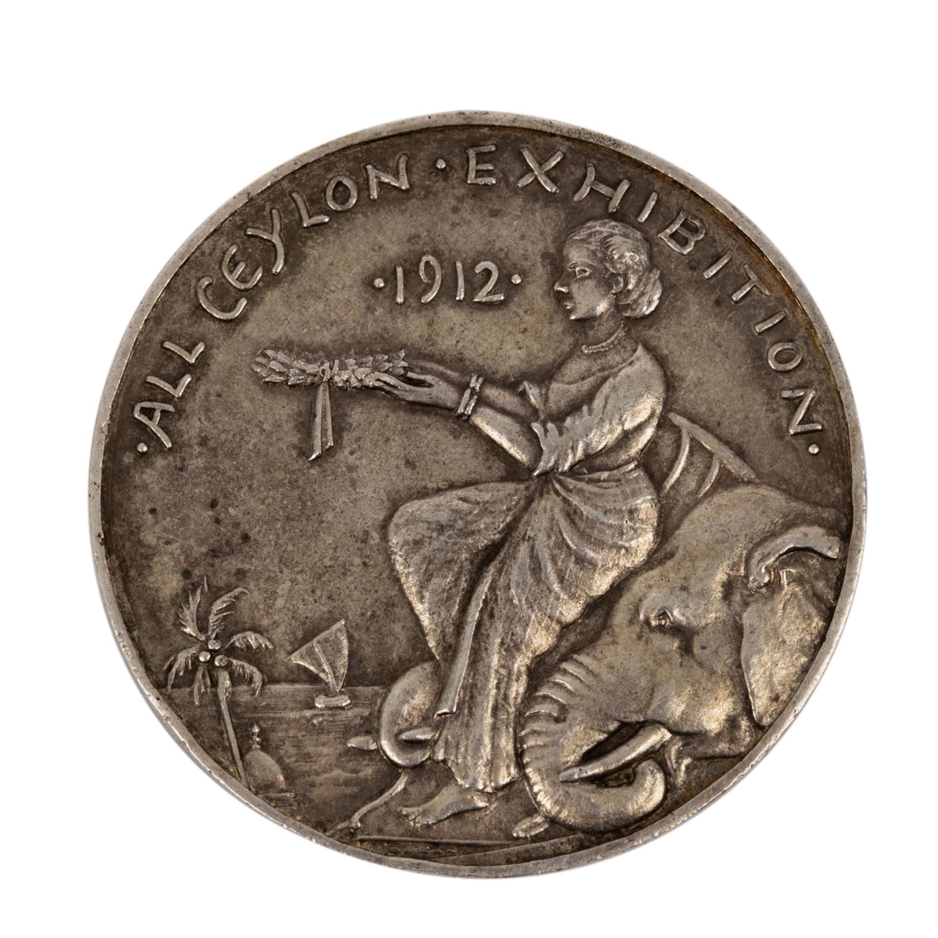Ceylon - Silberne Preismedaille 1912,All Ceylon Exhibition, Av: Frau hält Kranz, Elef