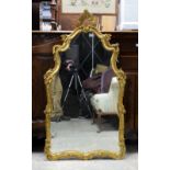 Gilt framed mirror with shaped plate and scroll decoration