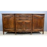 French oak breakfront sideboard, central section with two drawers over cupboard, flanked by