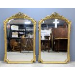 Pair of gilt framed mirrors with scroll, bow and floral decoration,