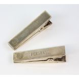 Pair of Tiffany and Co sterling silver desk tidy clips in the form of pegs, one marked 'Do it Today'