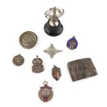 Silver trophy and a selection of silver sporting fobs and badges