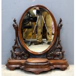 19th century mahogany oval bedroom mirror on shaped base with compartment