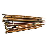 Seventeen walking sticks/riding crops, to include antler handles, another with a brass head handle