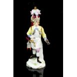 Unusual 19th Century Continental porcelain model of a cocoa seller, an urn on his back and cups on