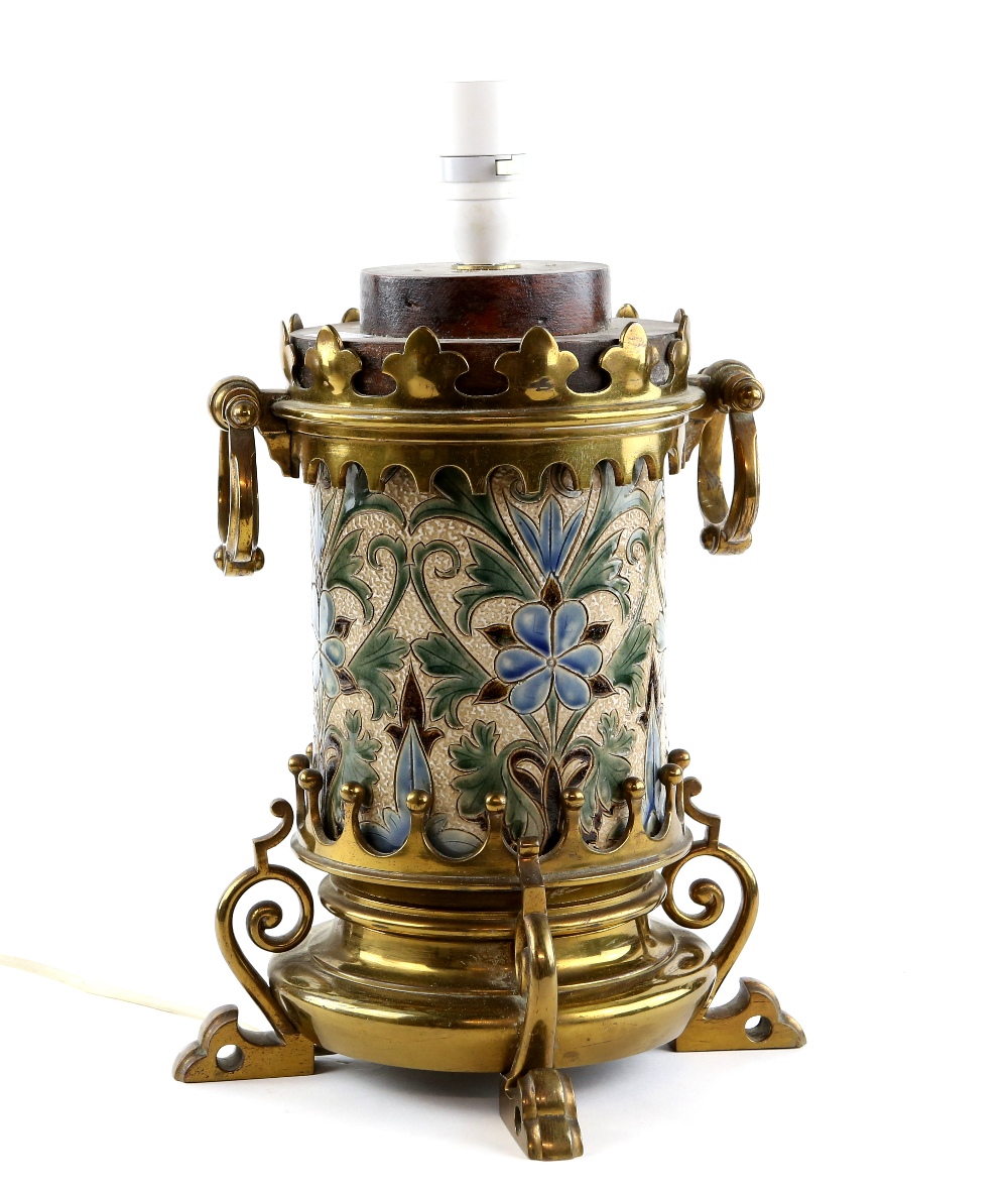 Doulton Lambeth stoneware lamp, incised formal floral decoration, in brass mount with scrolling feet