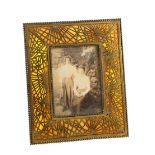 Tiffany Studios New York, an Art Nouveau picture frame, bronze and opalescent glass, in the pine