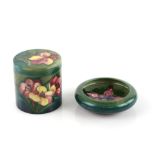 Moorcroft pottery an African Lilly pattern cannister, impressed marks, 9cm, and a Clematis pattern