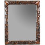 Early 20th C mirror, the wooden frame carved with ivy and laurel leaves, 64 x 80 cm.