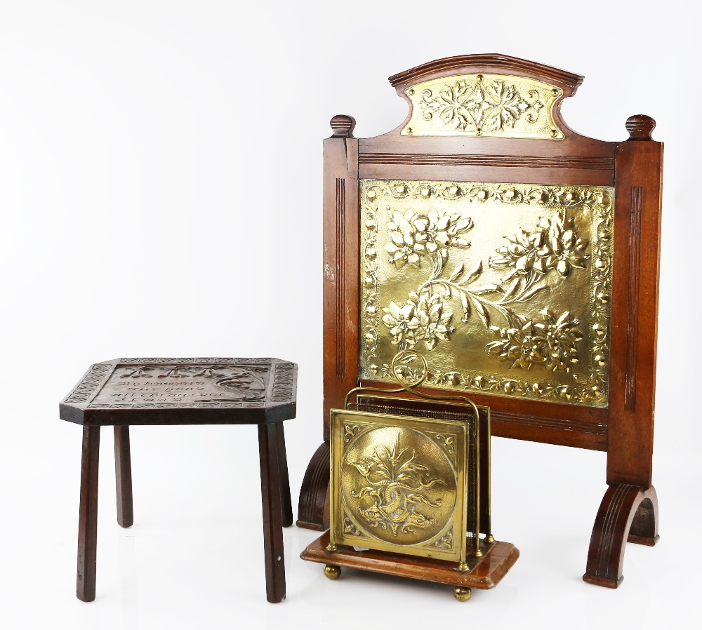 A fire screen in mahogany with Aesthetic Movement brass designed with flowers within a fruit border,