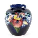 Moorcroft 'Orchid' pattern ovoid vase with tube lined decoration on a blue ground, painted and