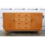 Heal & Sons, a golden oak sideboard in Cotswold School manner, with two plank panelled cabinets