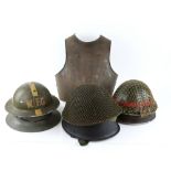 Six various steel helmets and a metal cuirass