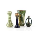 Four Art Pottery vases, a Gouda twin handled vase, another with Art Nouveau decoration, a