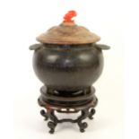 Chinese iron vessel on wooden stand, the wooden cover with hardstone finial.