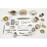 Group of silver and white metal items including an acorn-shaped rattle, cigar case, pill box, napkin