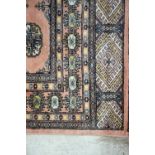 Persian rug the madder ground with multiple lozenges, 148cm x 107cm and a Persian design rug.