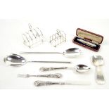 Group of silver items including a Victorian knife, fork and spoon set, two toast racks, salad