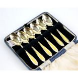 Cased set of six silver and yellow enamel spoons by D and B, Birmingham 1929.