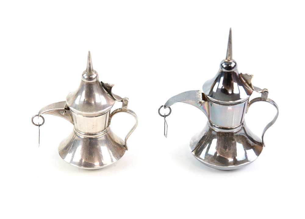 Two graduated size silver coffee pots.