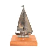 Silver model/statue of a sailing boat on a wooden base, London 1986.