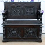 Stained oak monks bench with lion mask decoration, .