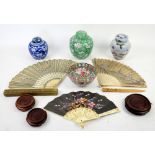 Collection of fans, ginger jars, three hardwood stands and a Cantonese bowl .