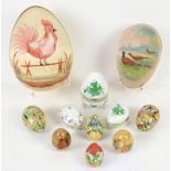 Three Herend porcelain eggs, four painted wooden eggs, and two painted silk eggs.