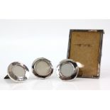 Four silver photo frames varied ages, three circular one rectangular .