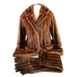A three-quarter length fur coat and two stoles .