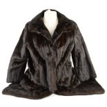 A mink full length coat and a fur wrap.