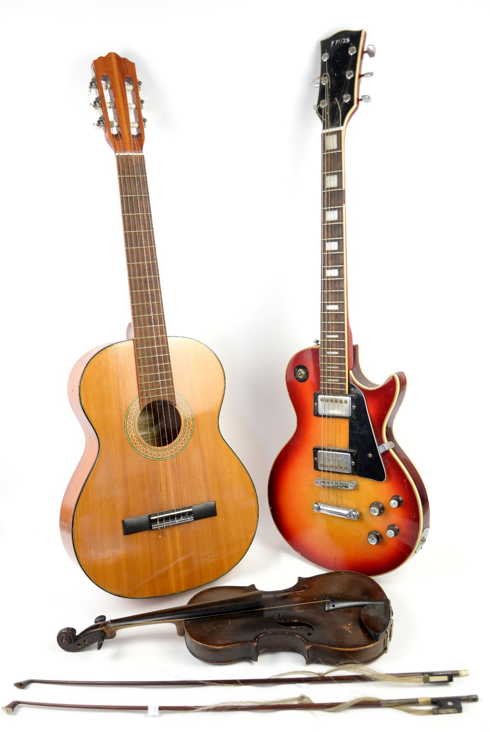 Solid body electric rhythm guitar, Resonata acoustic guitar and violin with two bows .