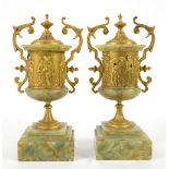 19th century pair of onyx and gilt-metal urns, 26 cm high.