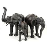 Set of three Elephant sculptures in leather, with man-made tusks, produced in India.