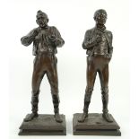 Lindel, pair of terracotta figures of men, on square bases, 34cm .