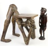 African carved hardwood stool as a a crouching man and another carved African figure.