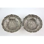 Pair of cherub embossed silver bon bon dishes with floral and butterfly embossing by Deakin and