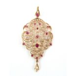 Floral open work pendant, set with oval cut rubies and seed pearls, mount testing as 14 ct,