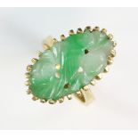 Jade ring,carved bird and fruit motif, tapering shank, mount stamped 18 ct and marked Jayem, ring