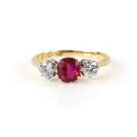 Three stone ring set with two diamonds and a synthetic ruby, diamond weight estimated at 0.50 carat,