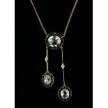 Edwardian negligee pendant set with oval faceted light blue sapphires; featuring central sapphire