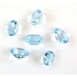 Six loose blue topaz gemstones, one rectangular step cut estimated weight 5.96 carats, and five oval