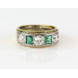 Emerald and diamond ring, three old cut diamonds and two square cut emeralds in gold channel