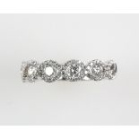 Contemporary diamond half eternity ring, set with five brilliant cut diamonds within a diamond