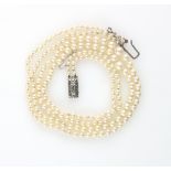 1930's double strand graduated pearl necklace to a silver clasp marked sterling, lengths 37 and 35